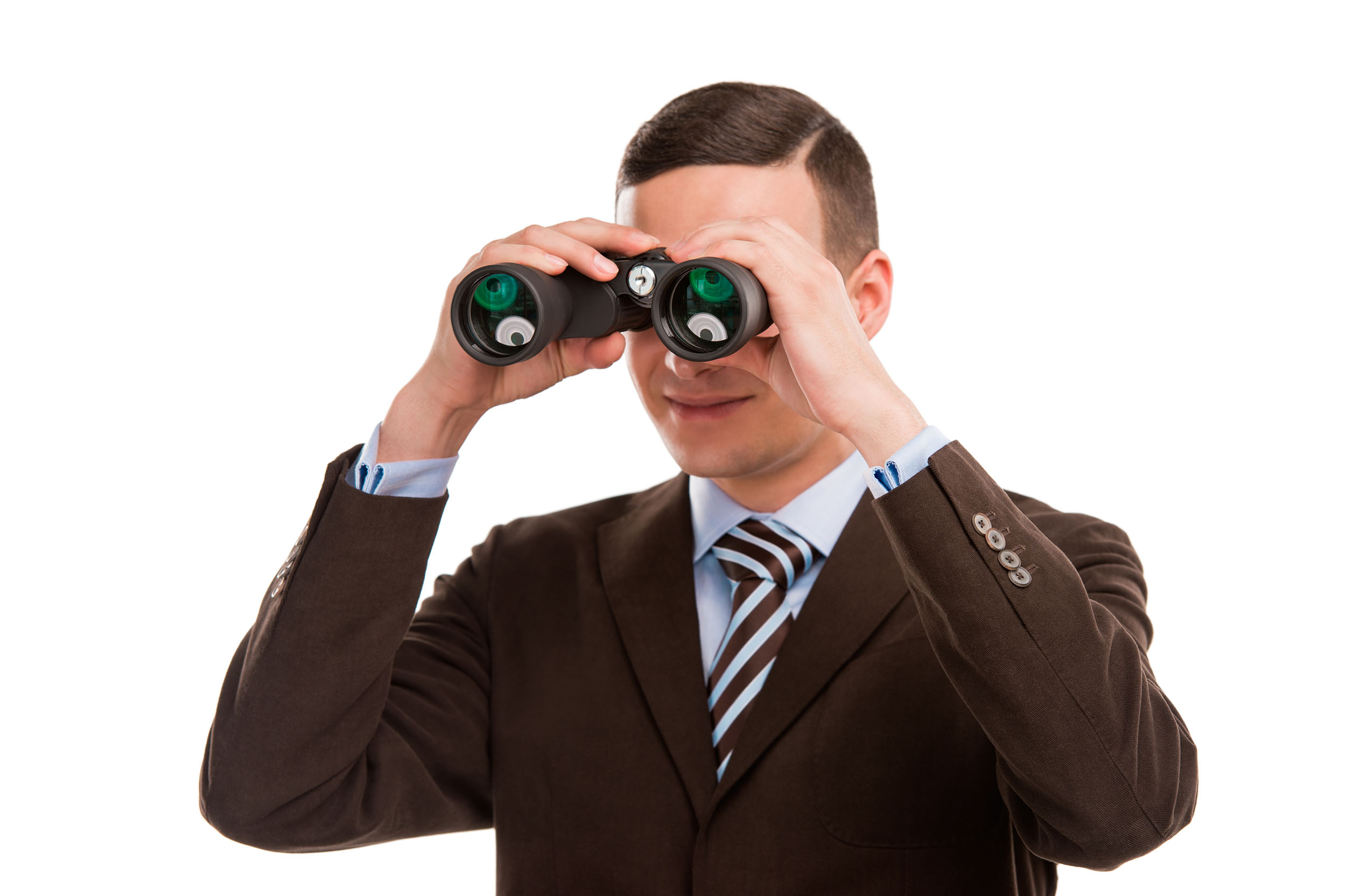 Closeup of a young business man looking through binocular isolated on white background