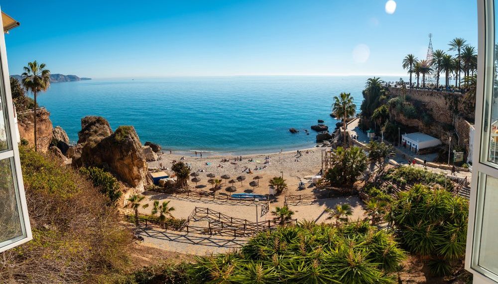 Panoramic of Calahonda beach in the town of Nerja with people sunbathing in spring, Andalusia. Spain. Costa del sol in the mediterranean sea