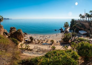 Panoramic of Calahonda beach in the town of Nerja with people sunbathing in spring, Andalusia. Spain. Costa del sol in the mediterranean sea
